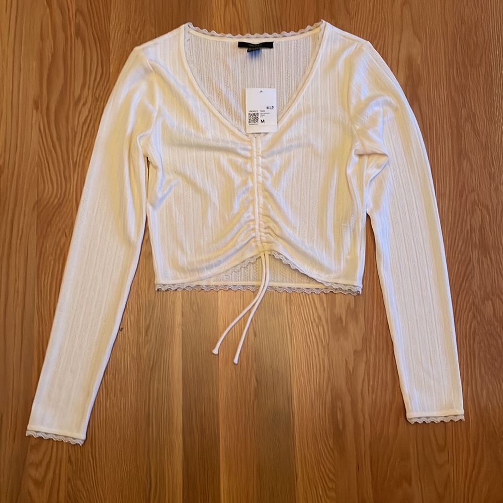 Long sleeve top with pull tie in front